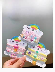 Detail of colorful acrylic beaded bracelets for girls with cute rainbow and cat charms