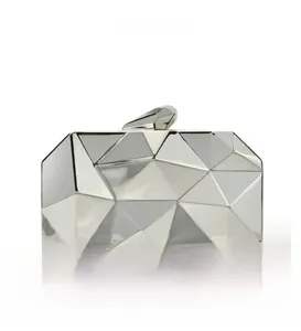 Close-up of a silver geometric faceted metal evening clutch with a polished prism clasp