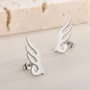 Macro detail of silver leaf wing stud earrings made of polished stainless steel