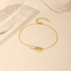 Detailed view of S925 silver gold bracelet featuring interlocking oval rings with pavé cubic zirconia