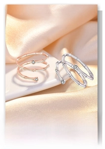 Detail of bamboo joint style rings with sparkling zircons on elegant silk background