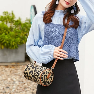 Vintage leopard print barrel crossbody bag with adjustable brown leather shoulder strap