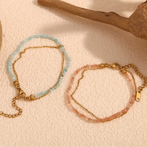 Detail of 18K gold-plated double-layer bracelets with opal beads and lobster clasp