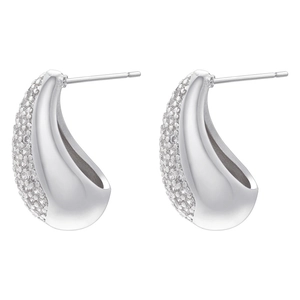 Macro shot of silver teardrop earrings with pave-set zircons and polished finish