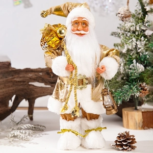 Detailed view of standing Santa doll in gold and white suit holding a vintage lantern