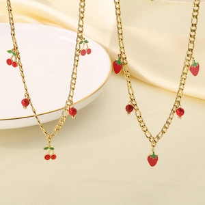Detail of 18K gold plated necklaces featuring cherry and strawberry fruit charms