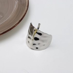 Detailed close-up showing the irregular hammered texture on the silver lava metal hair clip