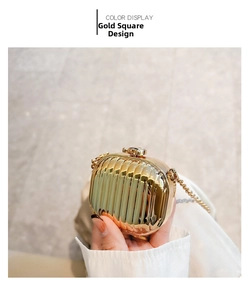 Detail of gold square evening bag with vertical pleated texture and diamond buckle