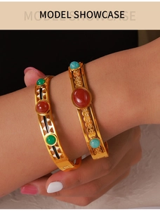Detail of vintage gold plated bangle with hollow patterns and colorful stones inlay