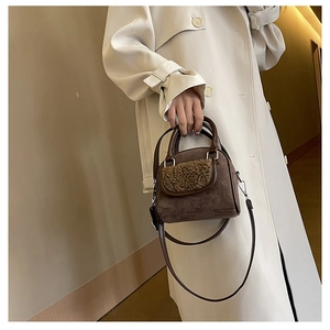 Detail of dark brown faux suede and teddy fur handbag with detachable shoulder strap