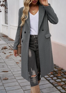Detail of grey double-breasted wool coat featuring lapels and practical side pockets