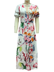 Detail of V-neckline with fabric buttons on a floral print bohemian maxi dress
