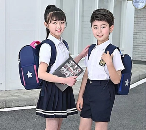 Detail of ergonomic kids backpack with mesh side pocket and school uniform set
