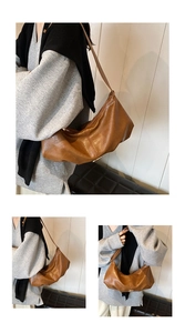 Detail of soft brown PU leather shoulder bag with sleek dumpling-style folding design