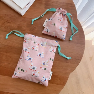 Detail of pink cotton drawstring pouches with cute duck boat prints in two sizes