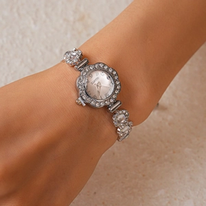 Silver flower-shaped rhinestone watch and bracelet set on wrist for an elegant look