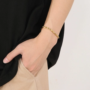 Close-up of a gold hip-hop style chain bracelet worn on a wrist for men and women