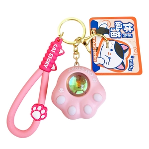 Pink silicone cat paw keychain with colorful laser surface and matching wrist strap