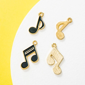 Gold and black enamel musical note pendants in eighth and sixteenth note styles