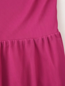 Macro shot of rose red mesh fabric texture and pleated stitching details on the dress