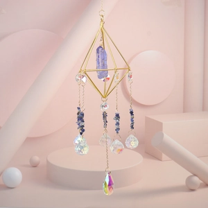 Detail of amethyst crystal suncatcher with gold geometric frame and teardrop pendant