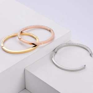 Detailed view of triple stacked 18K gold plated bangles with pave-set shimmering crystals