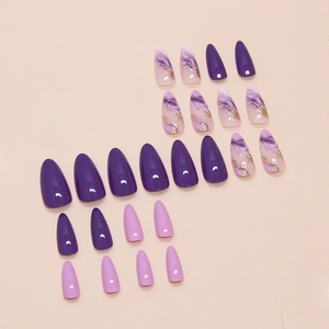 Almond-shaped purple marble press-on nails with gold foil accents and glossy finish