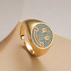 Detail of gold smile ring featuring micro-pave turquoise stones and open band design
