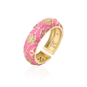 Detailed macro view of pink enamel flower ring with gold plating and cubic zirconia