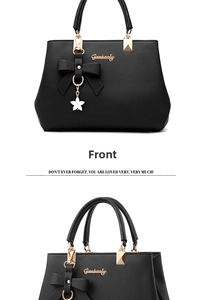 Front view of black bow-knot handbag with gold star pendant and lychee texture detail