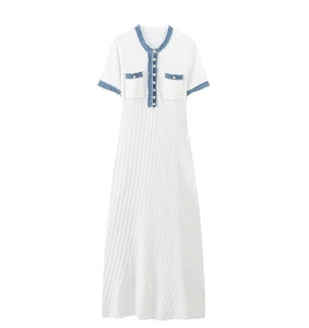 Detailed knit dress texture with contrast blue trim and pearl buttons on white fabric