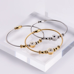 Three-piece stainless steel wire bracelets with heart zircon charms on acrylic blocks
