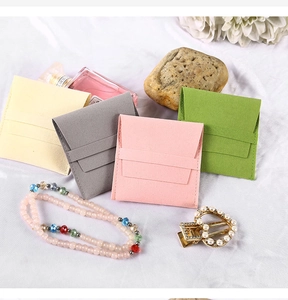 Pink, beige, grey and green microfiber jewelry pouches with flap closure and decorative props