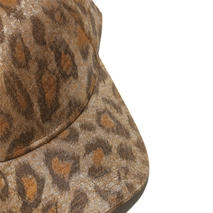 Close-up of leopard print baseball cap featuring gold metallic finish and fine stitching