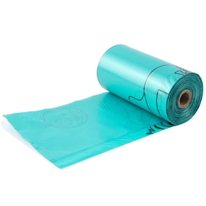 Detail of green biodegradable dog poop bag roll with paper core on a white background