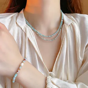 Elegant gold plated sky blue pearl necklace and beaded bracelet set on female model