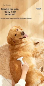 Macro shot of white pet grooming comb removing loose hair from a golden retriever