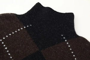 Close-up of the diamond pattern knit sweater showing the soft texture and neckline detail