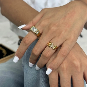 Close-up of 18k gold rings with rectangle and triangle crystals on model hand