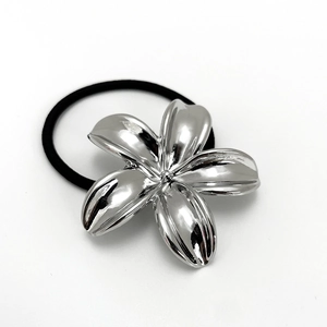 Close-up of a silver flower metal ornament on a high-elastic black hair tie for women