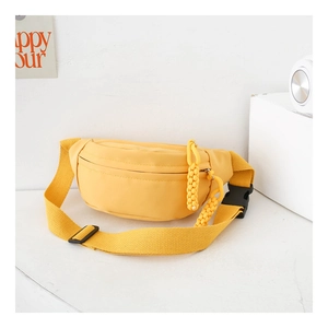 Detail of a bright yellow canvas waist bag for kids with adjustable strap and buckle