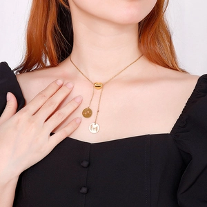 Minimalist gold heart Y-necklace with family silhouette pendants on a female model