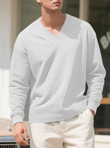 Close-up of white V-neck sweater showing textured waffle knit and cable details