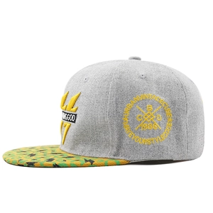Detail of embroidered grey hip-hop cap featuring yellow lightning pattern on the brim