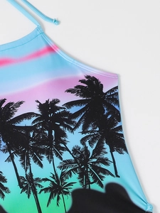 Detailed close-up of tropical palm tree print and drawstring straps on the bikini top