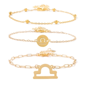 Three-piece golden Libra zodiac bracelet set for women on a clean white background