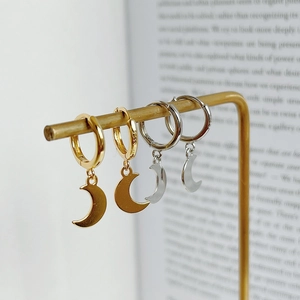 Detail view of gold and silver S925 sterling silver moon pendant earrings with hallmarks