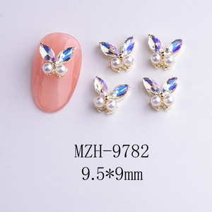 Macro view of 3D butterfly nail charms with aurora rhinestones and faux pearls