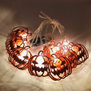 Halloween orange pumpkin LED string lights with battery box emitting warm white glow