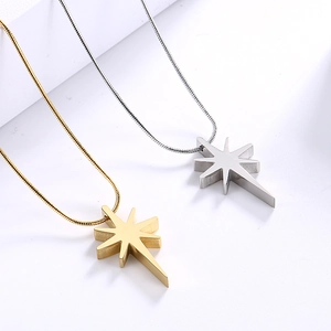 Detailed view of gold and silver octagonal star pendants on delicate snake chains